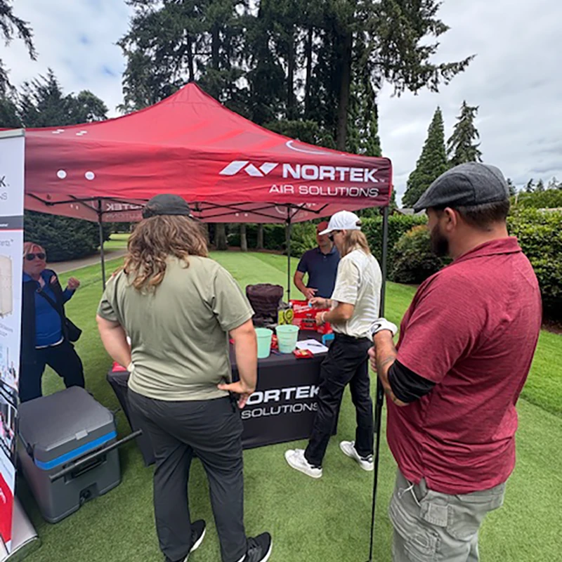 Golfers visit the Nortek Air Solutions booth at the Tualatin Chamber Golf Classic in Tualatin, Oregon.