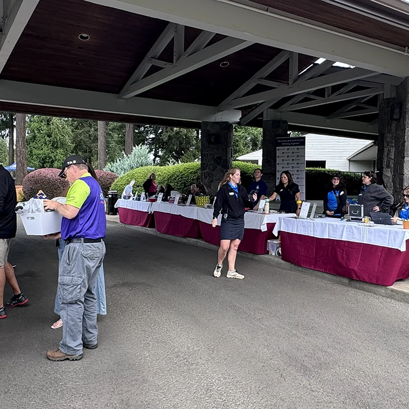 Event registration tables at the Tualatin Chamber Golf Classic in Tualatin, Oregon.